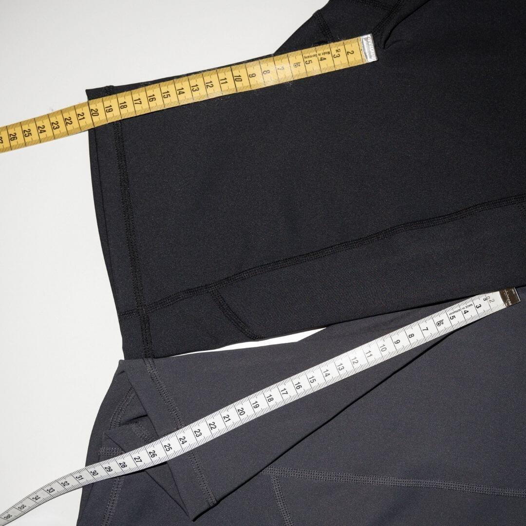 Top down view of the inseams of the two lengths of biker shorts (20 and 25cm). Measuring tape is shown measuring both the inseams.